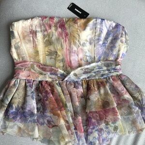 Express strapless peplum top with a floral print.